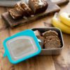 Klean Kanteen food box storing and cutting banana bread in lunch overhead